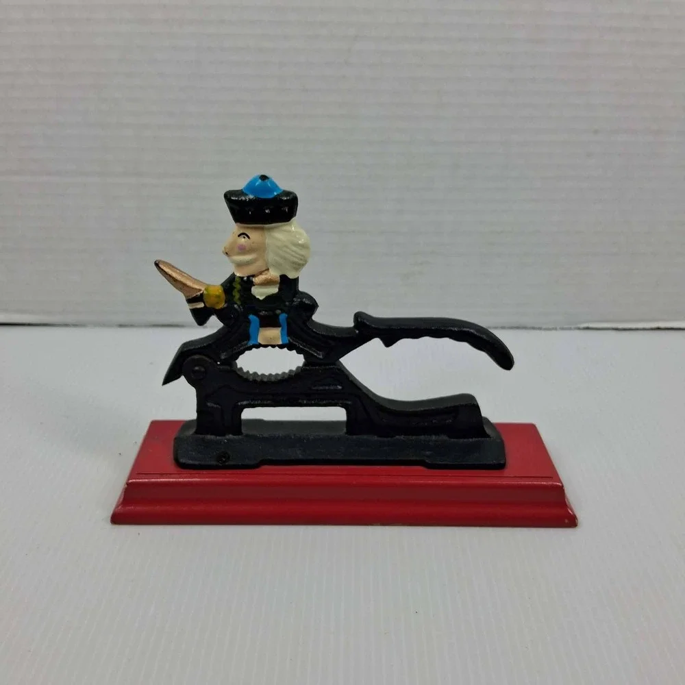 Vintage Cast Iron Mechanical Nutcracker Soldier Figure on Red Wood‎ Base Black